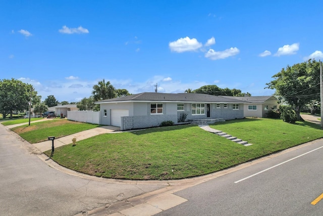 single story home featuring a garage and a front yard