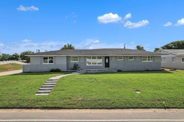 single story home featuring a front lawn