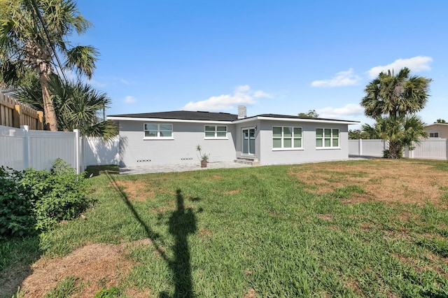 rear view of house with a lawn