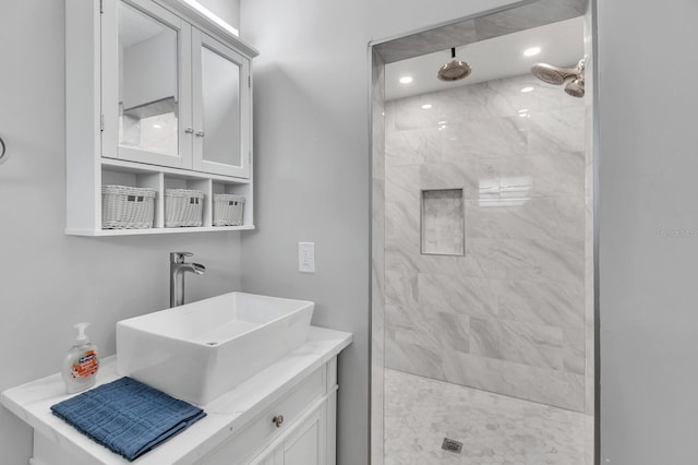 bathroom with vanity and tiled shower