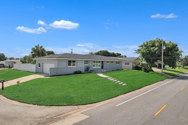 single story home with a garage and a front lawn