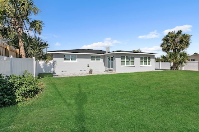 rear view of house with a yard