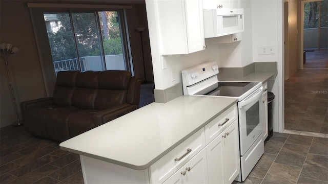 kitchen featuring white cabinetry, white appliances, and kitchen peninsula