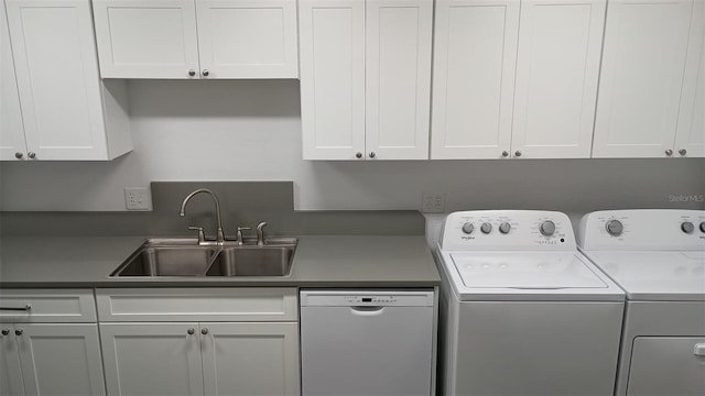 clothes washing area featuring sink and washing machine and clothes dryer