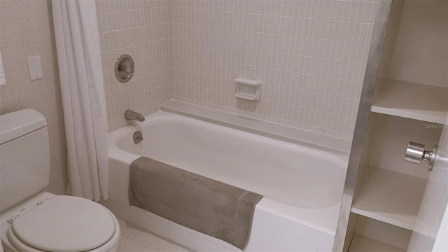 bathroom with toilet and shower / bath combo