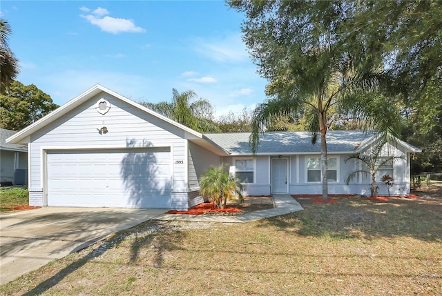 ranch-style home with a garage and a front lawn