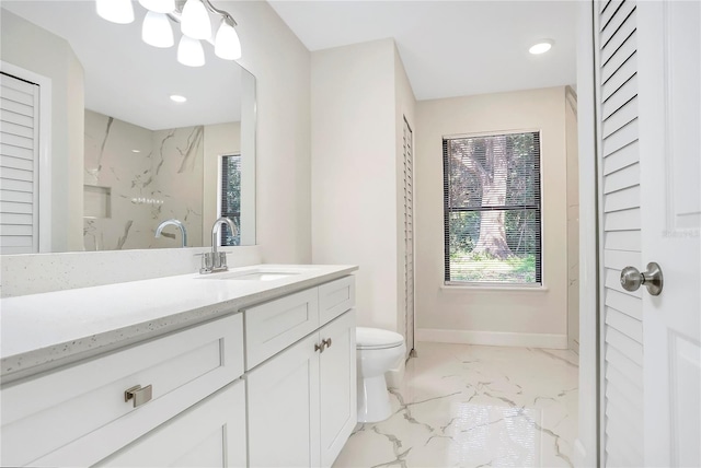 bathroom featuring vanity, toilet, and a tile shower