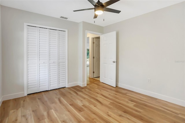 unfurnished bedroom with ceiling fan, light hardwood / wood-style floors, and a closet