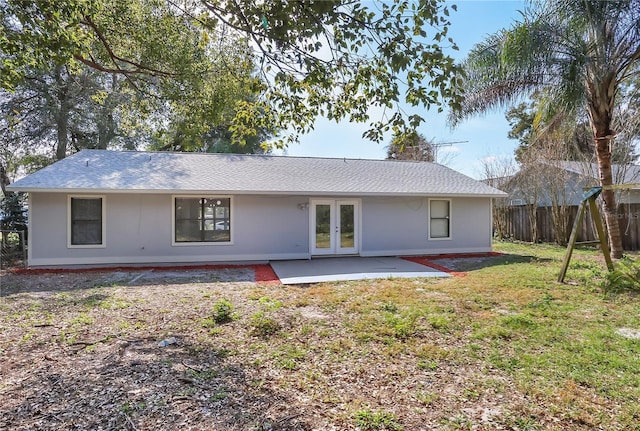 rear view of house with a patio, a yard, and french doors