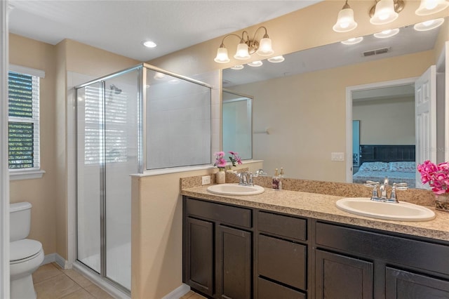 bathroom featuring vanity, tile patterned floors, toilet, and walk in shower