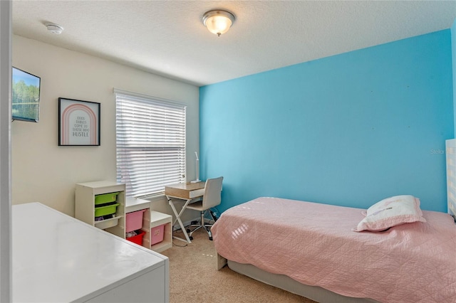 carpeted bedroom featuring a textured ceiling