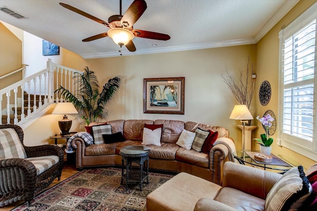 living room featuring ornamental molding, hardwood / wood-style floors, and ceiling fan