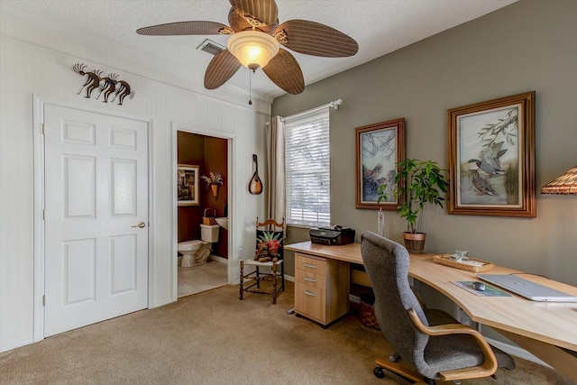 office space featuring ceiling fan, light carpet, and a textured ceiling