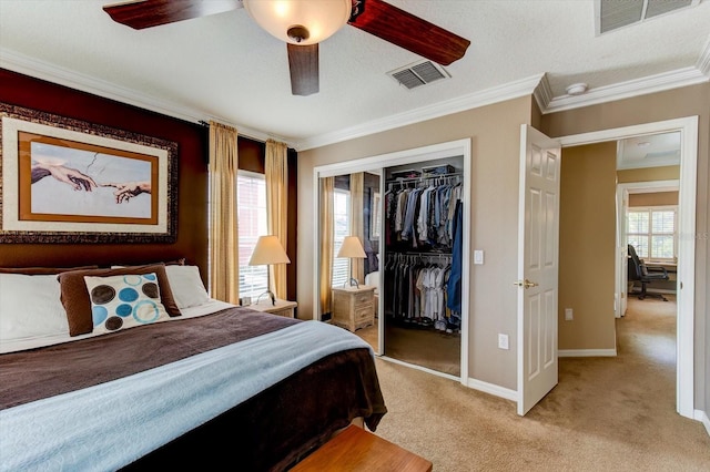 bedroom with multiple windows, ornamental molding, light colored carpet, and a closet