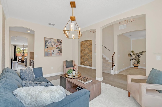 living room featuring an inviting chandelier and light hardwood / wood-style flooring