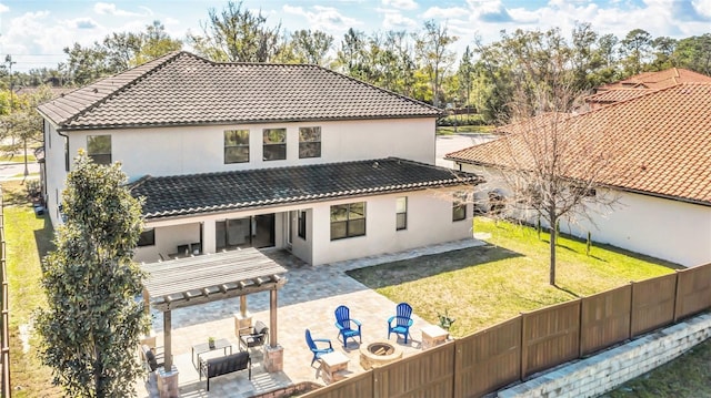 back of house featuring a pergola, a yard, a patio area, and an outdoor fire pit