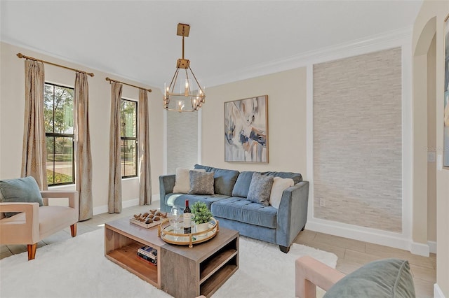 living room with ornamental molding and a chandelier