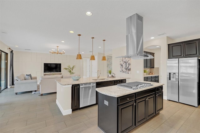 kitchen featuring sink, island range hood, a center island, hanging light fixtures, and appliances with stainless steel finishes