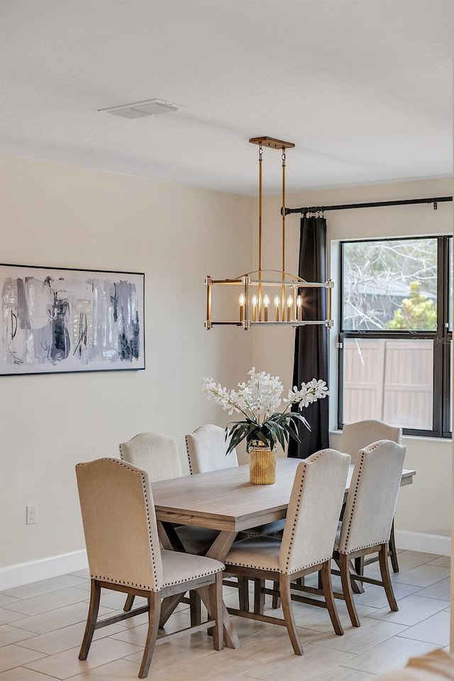 dining space featuring a chandelier