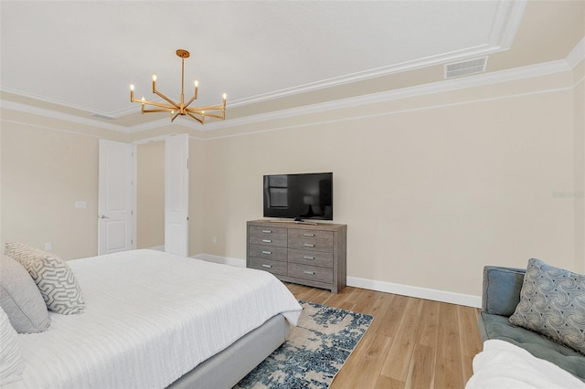 bedroom featuring crown molding, a chandelier, and light hardwood / wood-style floors