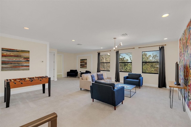 carpeted living room with a chandelier