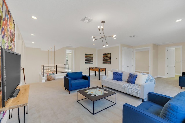 living room with light carpet and a chandelier