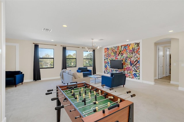 game room featuring an inviting chandelier and light carpet