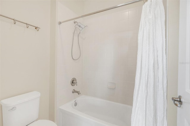 bathroom with shower / tub combo with curtain and toilet