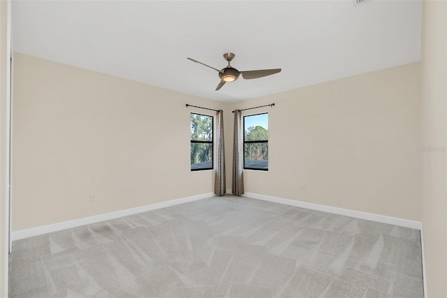 carpeted empty room featuring ceiling fan