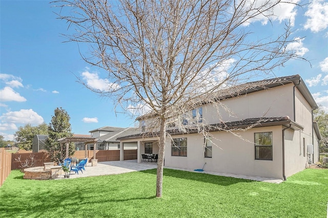 back of property with an outdoor fire pit, a pergola, a patio area, and a lawn