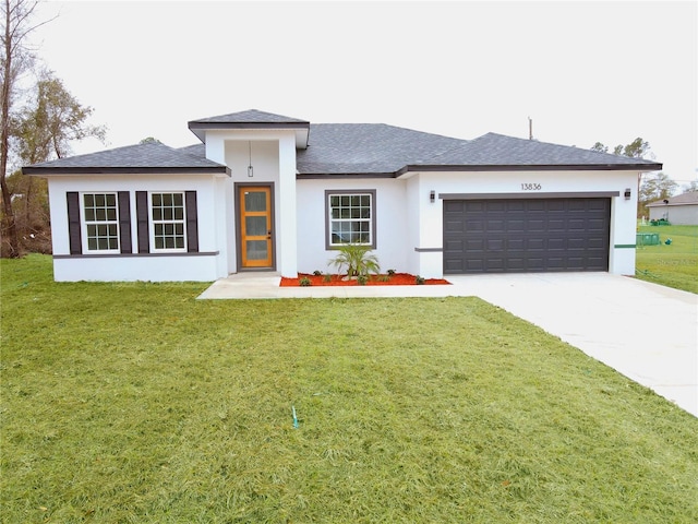 view of front facade featuring a garage and a front lawn