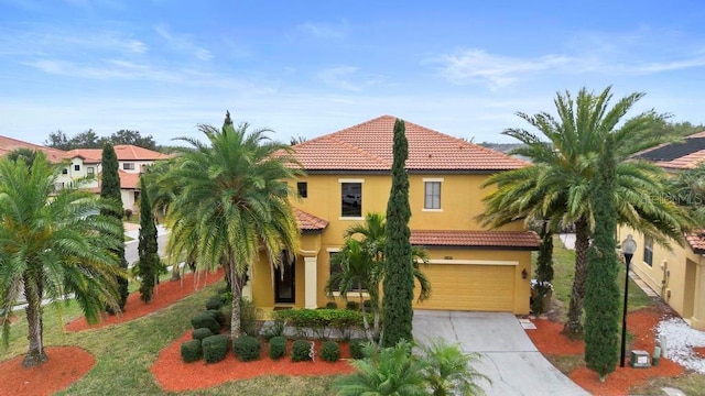 mediterranean / spanish house with a garage