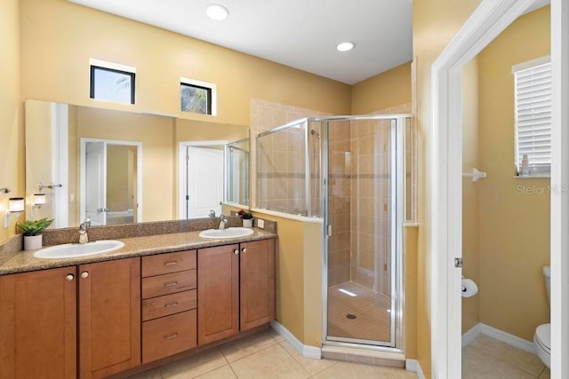 bathroom featuring an enclosed shower, vanity, tile patterned floors, and toilet