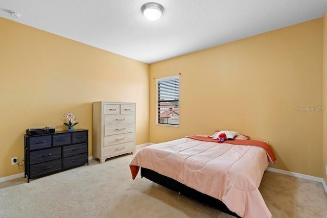 bedroom featuring light colored carpet