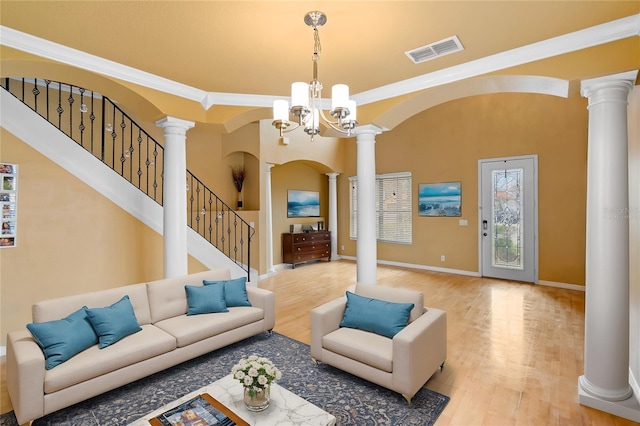 living room featuring hardwood / wood-style flooring and decorative columns