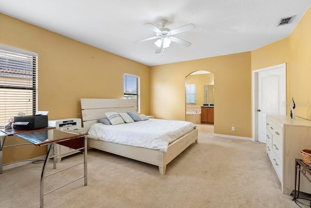 carpeted bedroom featuring ensuite bathroom and ceiling fan