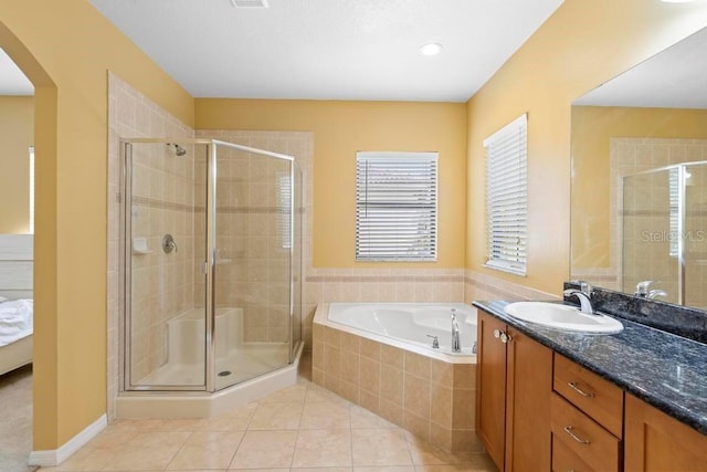 bathroom featuring shower with separate bathtub, tile patterned floors, and vanity