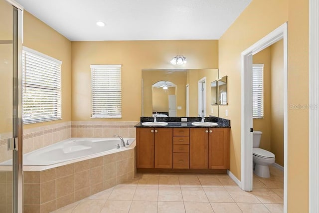 full bathroom featuring tile patterned flooring, vanity, toilet, and separate shower and tub