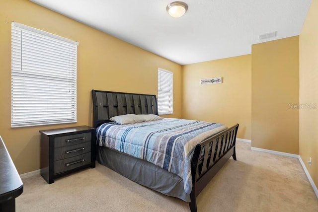 bedroom featuring light colored carpet