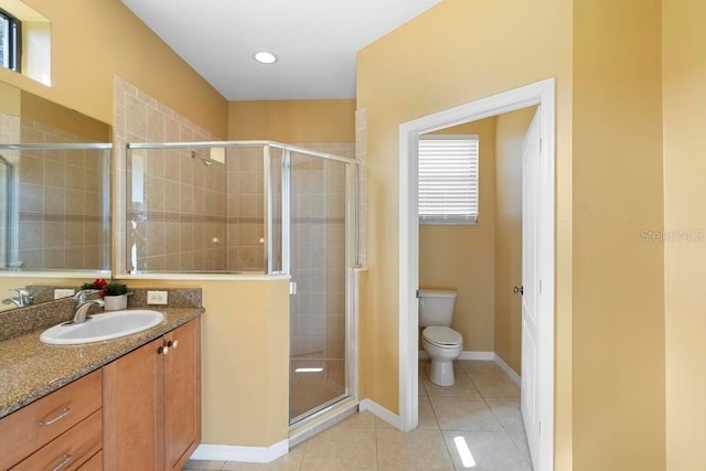 bathroom with vanity, toilet, an enclosed shower, and tile patterned flooring