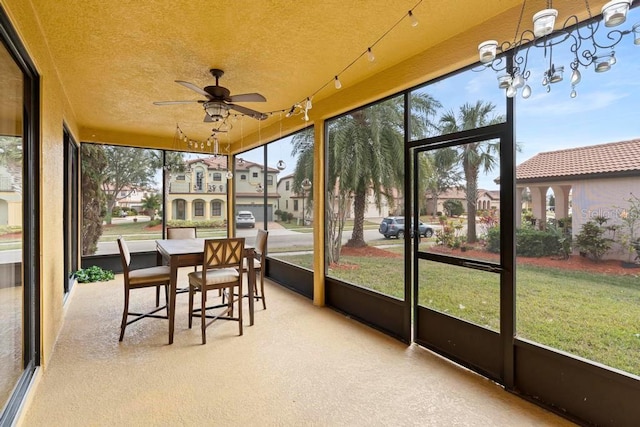 sunroom / solarium featuring plenty of natural light and ceiling fan