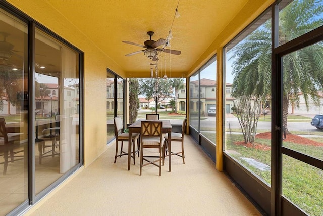 sunroom / solarium featuring ceiling fan