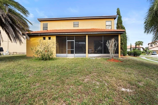 back of house featuring a yard and a sunroom