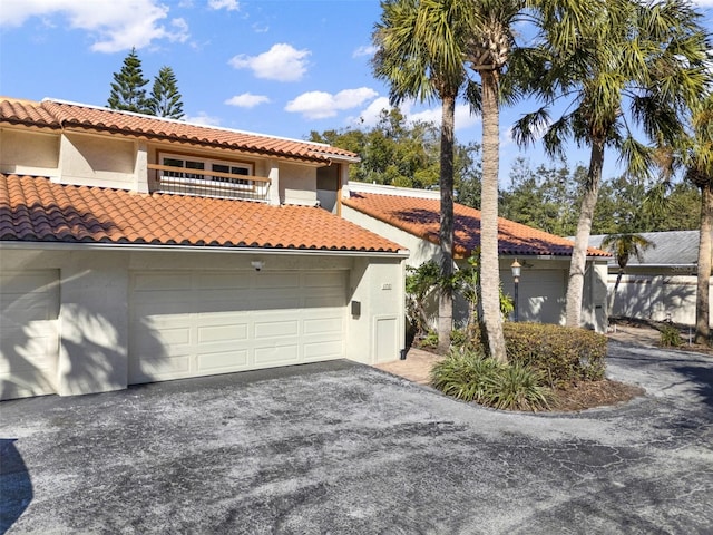 mediterranean / spanish-style home featuring a balcony and a garage