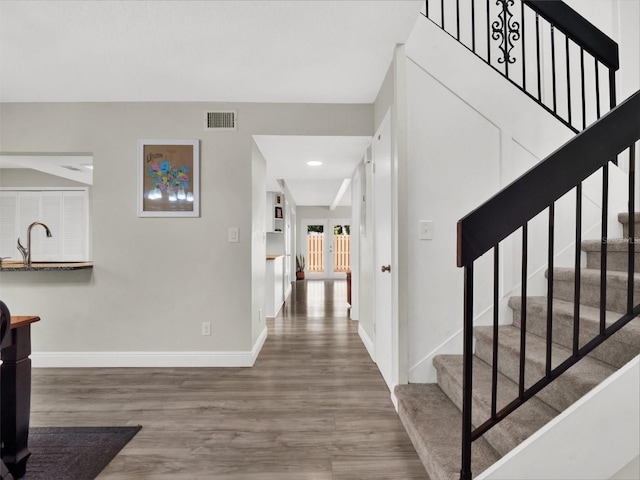 entrance foyer with hardwood / wood-style flooring, sink, and french doors