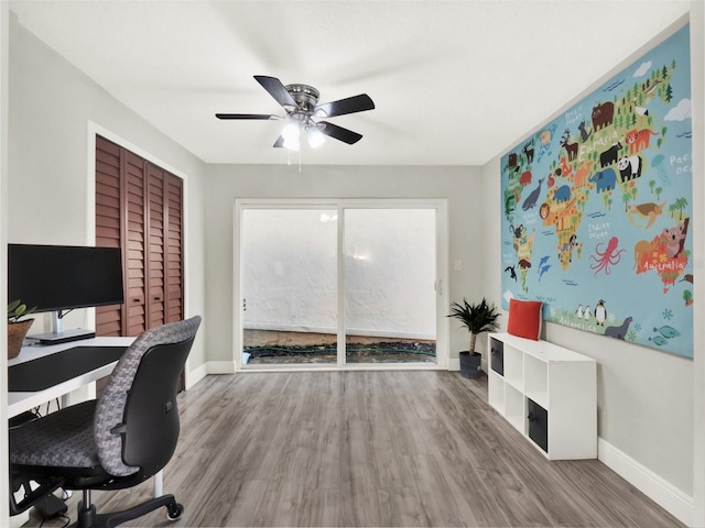 home office with wood-type flooring and ceiling fan