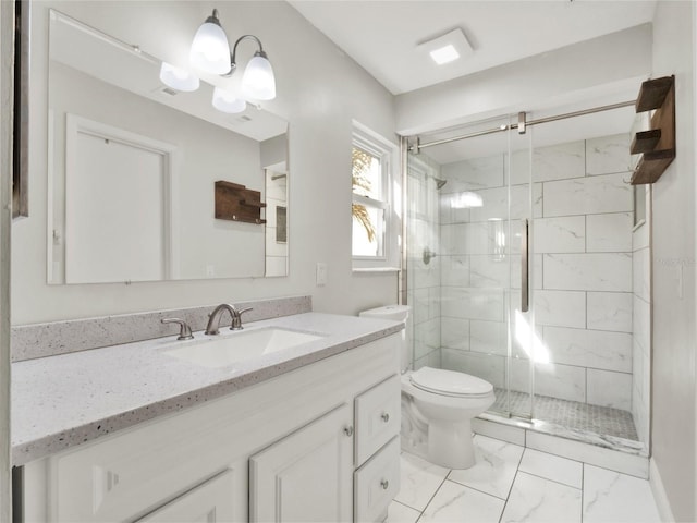 bathroom with a shower with door, vanity, and toilet