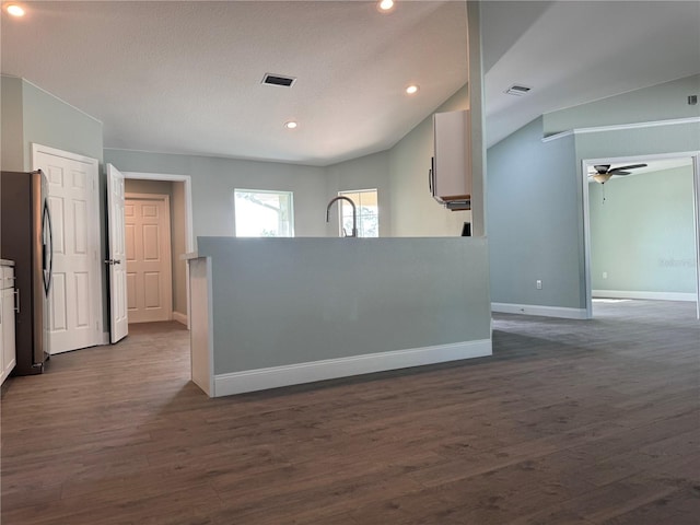 kitchen featuring white cabinets, ceiling fan, stainless steel refrigerator, and dark hardwood / wood-style floors