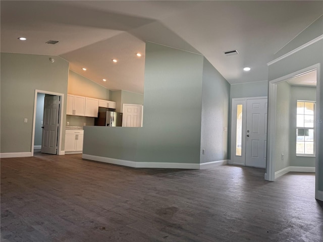 unfurnished living room with high vaulted ceiling and dark hardwood / wood-style floors