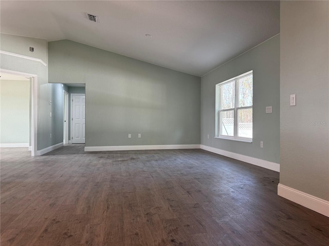 unfurnished room with vaulted ceiling and dark hardwood / wood-style floors